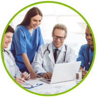 Medical professionals looking at a laptop